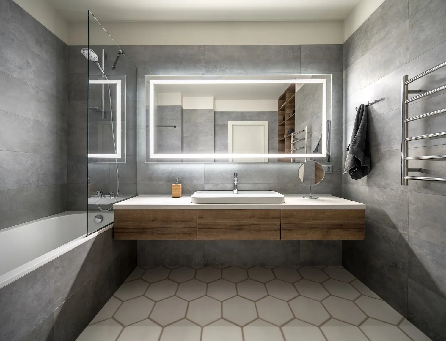 Modern bathroom renovation with concrete-look tile and timber vanity