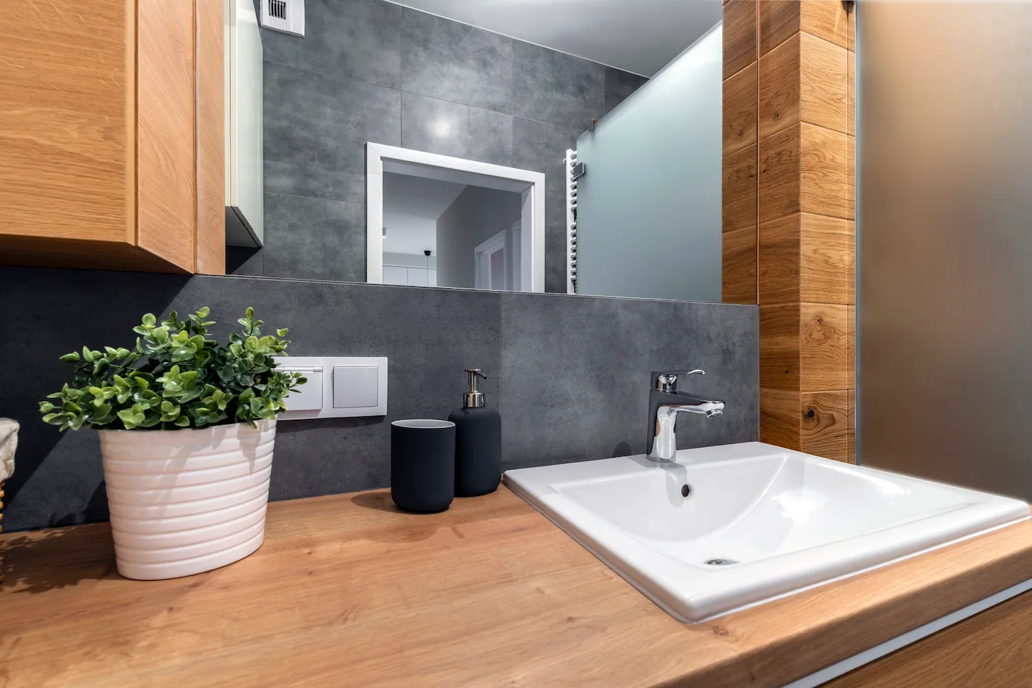 Close-up of a sink and tap on a timber vanity counter