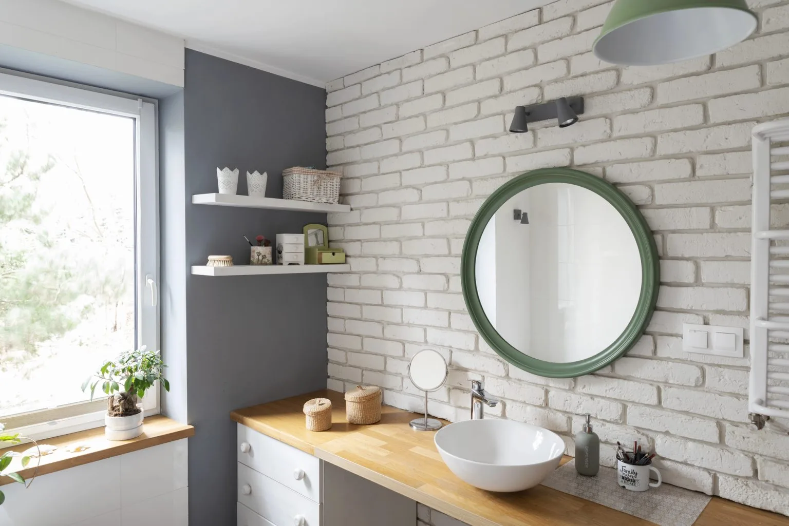 Custom bathroom design with white brick wall and green round mirror