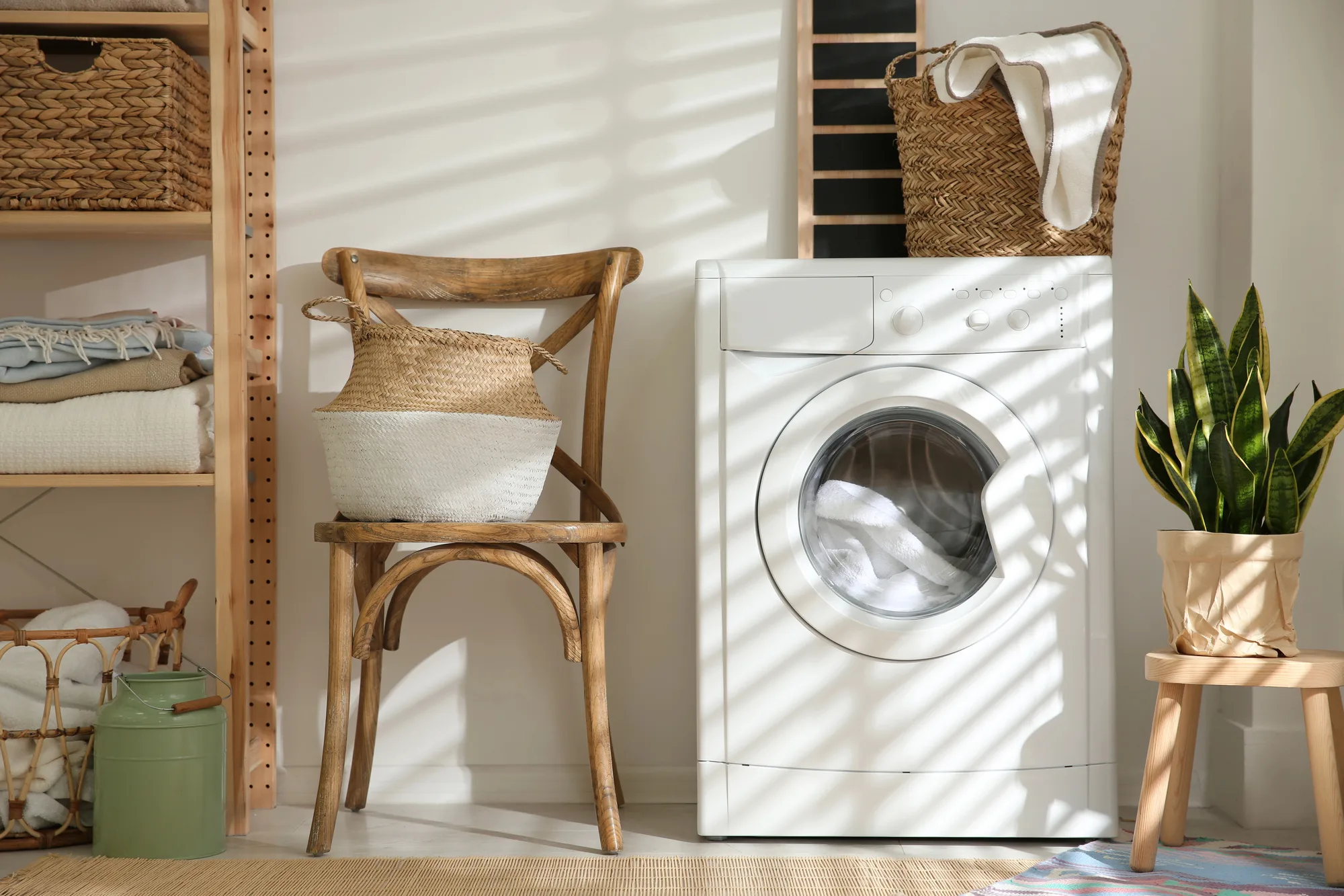 Sunlit laundry with woven baskets and a timber chair